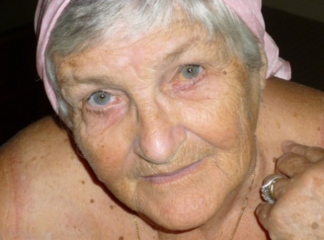 Obese grandmother licks her own nipples as she strips naked in living room 26992670