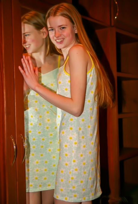 Leggy 18-year-old Avril A plays with her long red hair while getting naked 35642654