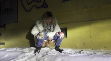 Blonde chick Jessy takes a piss on snow-covered ground at night 30025883